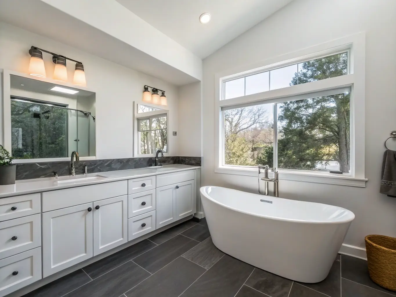 A beautifully remodeled bathroom with modern fixtures, elegant tile work, and custom cabinetry, showcasing a spa-like retreat created by Krew Home Remodeling.